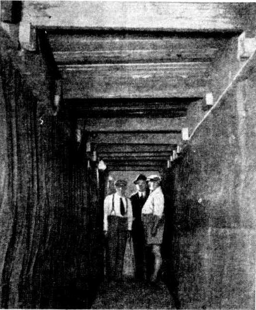 Three men standing in underground shelter at Glenwood Avenue