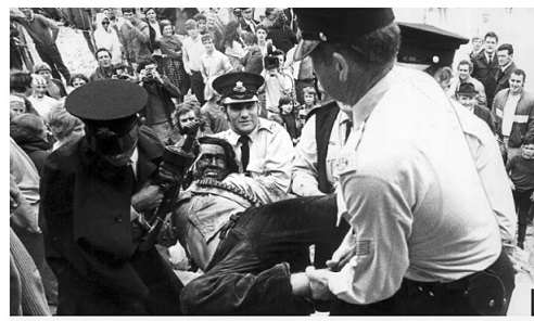 Police carry protestor away at Coogee